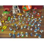 A large collection of 1970's - 1980's smurfs along with windmill house and mushroom house and 00