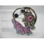 A silver and enamelled brooch/pendant in the Art Nouveau style set with sapphires and rubies