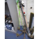 A pair of skis and poles together with a vintage ceiling light