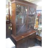 An Edwardian mahogany bookcase cabinet, dentil moulded cornice above twin astrigal glazed doors
