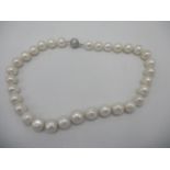 A pearl necklace with a 9ct white gold ball clip