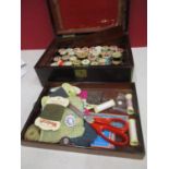 A 19th century rosewood sewing box A/F and contents to include Dewhurst and Coates wooden cotton