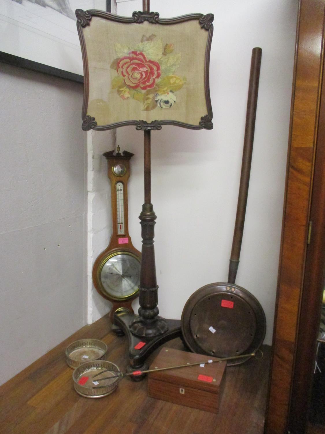 A Regency mahogany pole screen, a barometer, a pair of wine bottle coasters, a warming pan, a