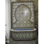 A 20th century Moroccan fountain tiled in a floral mosaic design in red, blue, green, yellow and