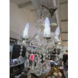 A cut glass four branch ceiling chandelier