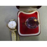 A gold coloured metal ring set with a purple cabochon, stamped 750 and a Camy gold plated ladies