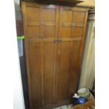 An early 20th century oak two door wardrobe, having fitted shelves and drawers 72" H x 37 1/4" W