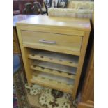 A modern kitchen pine butchers style unit with wine rack below