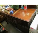 An early 20th century mahogany sideboard having a raised back above drawers and cupboard doors