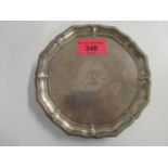 A Victorian silver card tray, with gadrooned edge, on three cast feet, engraved crest to centre,