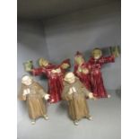 A pair of Austrian painted pottery candleholders in the form of two monks, together with two other