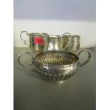 Silverware to include two mugs each with engraved initials, and a matching cream jug and sugar