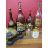 Collectables to include four large glass wine bottles, stoneware bottles and kitchen scales