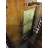 A vintage walnut wardrobe having a glass door above two drawers flanked by two doors
