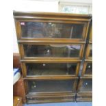 An early 20th century oak cased Globe Wernicke four section bookcase with single base drawer, makers