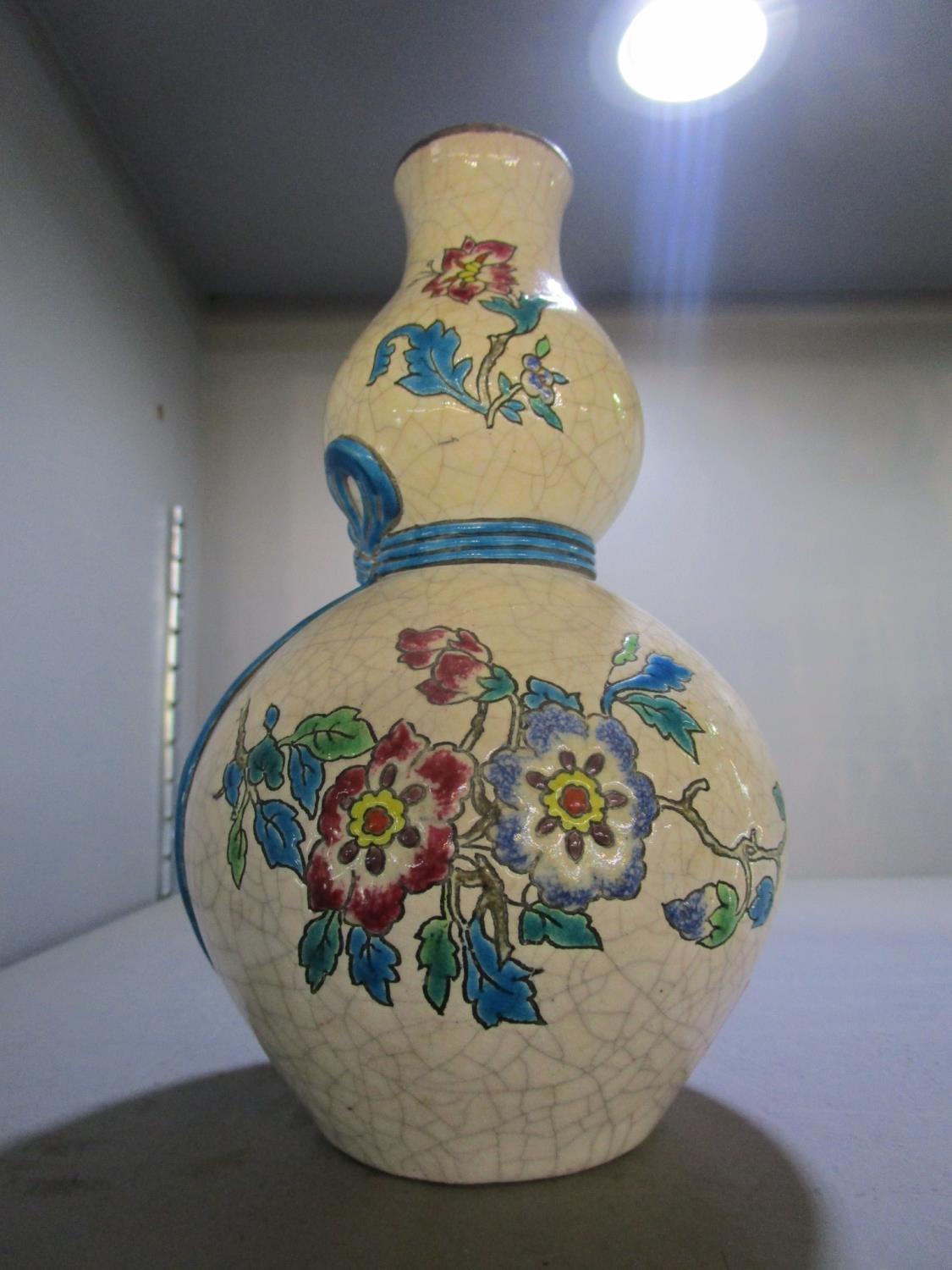 A Longwy double gourd pottery vase with resized floral enamelled decoration on a crackle glazed