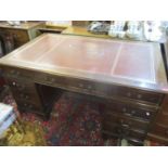 A reproduction mahogany twin pedestal desk having a leather topped scriber and nine drawers with