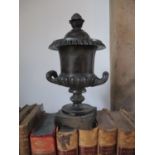 A Victorian bronze garniture candlestick having an Adams style urn