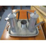 A four piece pewter coffee set with spot hammered decoration