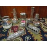 A quantity of 19th and 20th century glass dressing table pots with silver and white metal lids and a