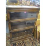 An early 20th century Globe Wernicke oak three tier bookcase with drawer below 47" H x 34" W