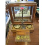 A Becker, Hatton Hall, London set of scales and various weights housed in a display case with drawer