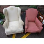 An Edwardian upholstered wing armchair, together with an antique armchair upholstered, sitting on