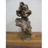 An Art Nouveau spelter bust of a young woman