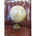 A Replogle 12" diameter World Classic cream coloured globe on a brass stand