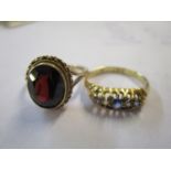 A 9ct gold ring set with a red cabochon and an 18ct gold ring set with diamonds and sapphires (2)