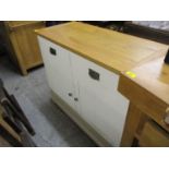 A modern off white painted kitchen cabinet with an oak top with two short drawers, on bracket feet