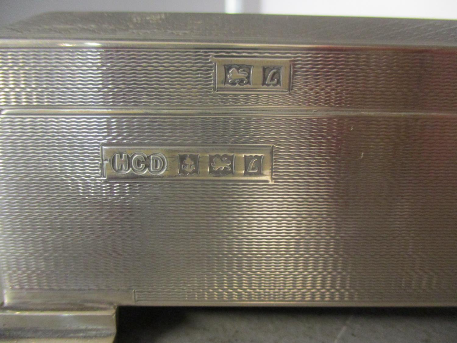 A silver cigarette box, wooden lined, on four graduating feet. Total weight 573g - Image 4 of 4