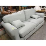 A modern contemporary pastel green upholstered two seater sofa bed