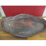 A large Oriental black papermache tray with red painted scenes