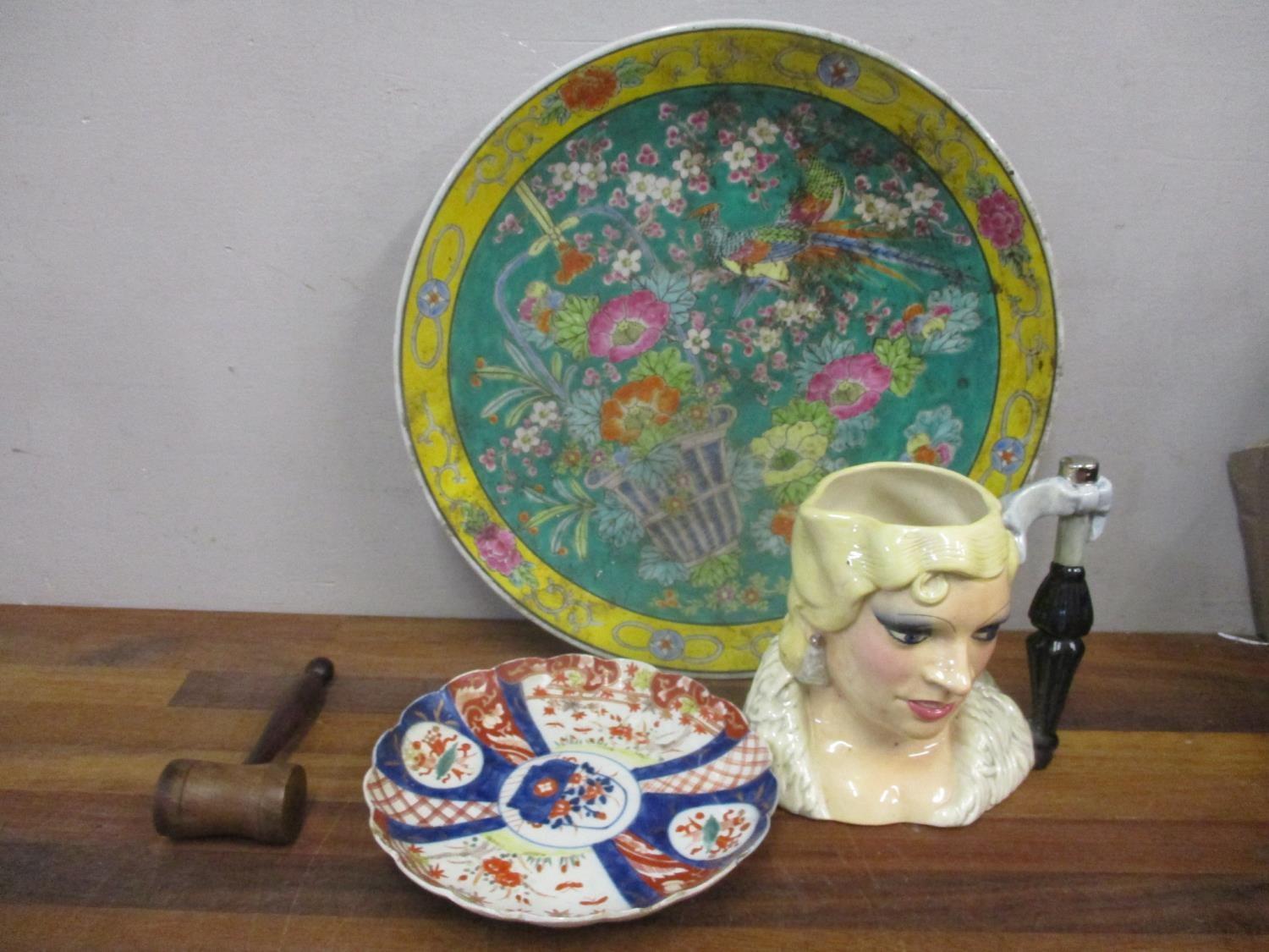 Japanese porcelain wall chargers, a pottery character jug and a wooden gavel