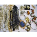 Costume jewellery to include an amber and bead necklace and an orange glass brooch A/F