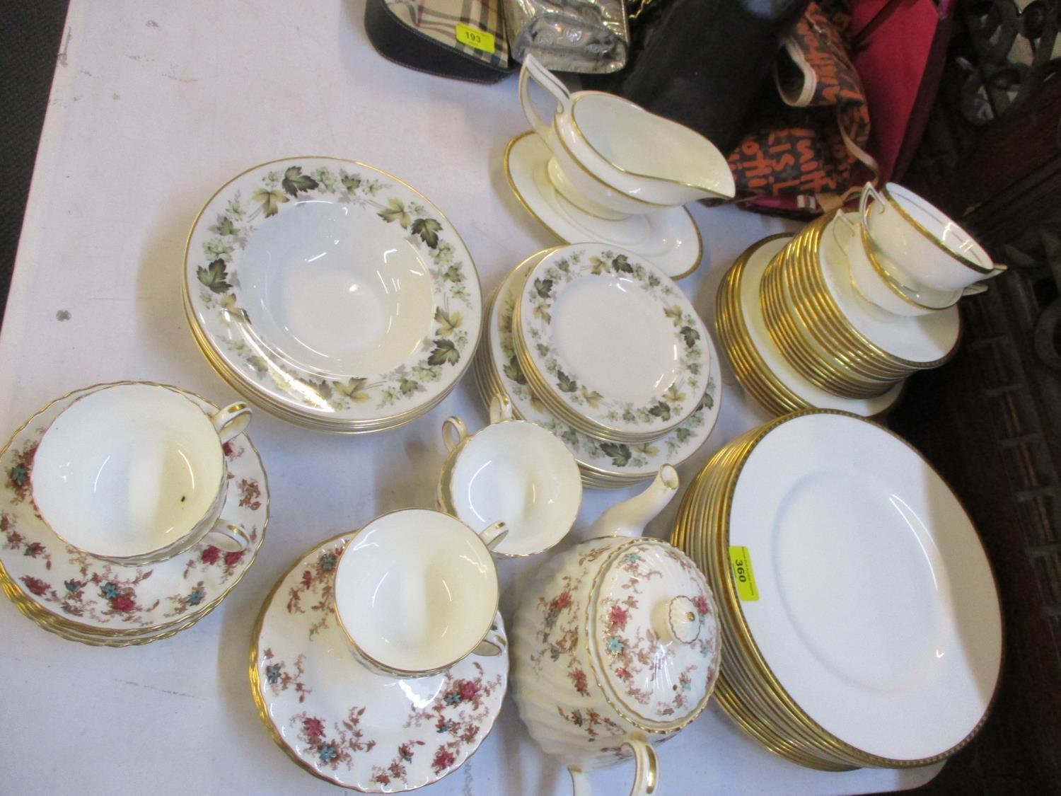 A Minton Golden Heritage part dinner service having a white ground with gold coloured rim,