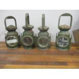 A group of four green painted oil railway lamps, circa 1940s