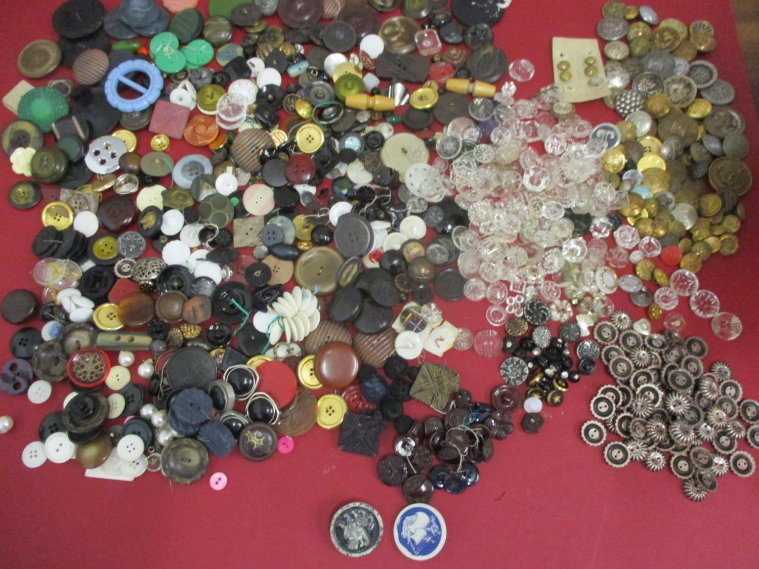 A collection of early 20th century fabric covered buttons, military and blazer buttons, vintage