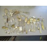 A mixed lot of silver plated flatware to include two grape scissors, berry spoons and other items