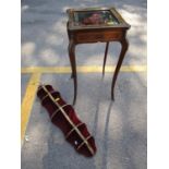 Mahogany and inlaid brass display table with glazed top, applied brass plaques to the legs, and a