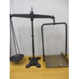 A Victorian shop scales having a black wrought iron frame and a brass tray