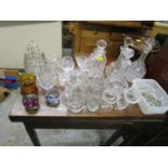 A mixed lot of glassware to include two Caithness glass paperweights, cut glass decanters, various