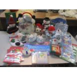 A mixed lot of Christmas items to include snowman soft toys, ear muffs and slippers, together with
