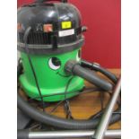 A green George Hoover vacuum cleaner with attachments
