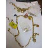 A Juicy Couture necklace and bracelet, gold coloured with various charms and mixed costume jewellery