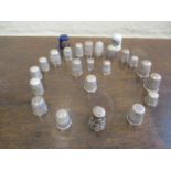 A collection of thimbles to include silver examples. Total weight of metal thimbles, 102g
