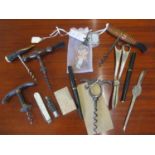 A selection of early to mid 20th century corkscrews, a novelty key ring, mixed silver plate and a