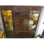A late 19th/ early 20th century mahogany large wardrobe having two mirrored doors flanking two