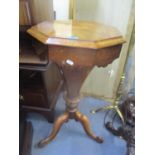 A Victorian walnut octagonal topped sewing table having a hinged top revealing fitted compartments